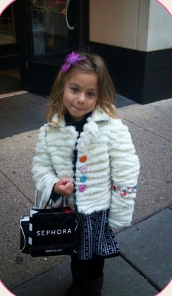Monique as a little girl holding a Sephora bag